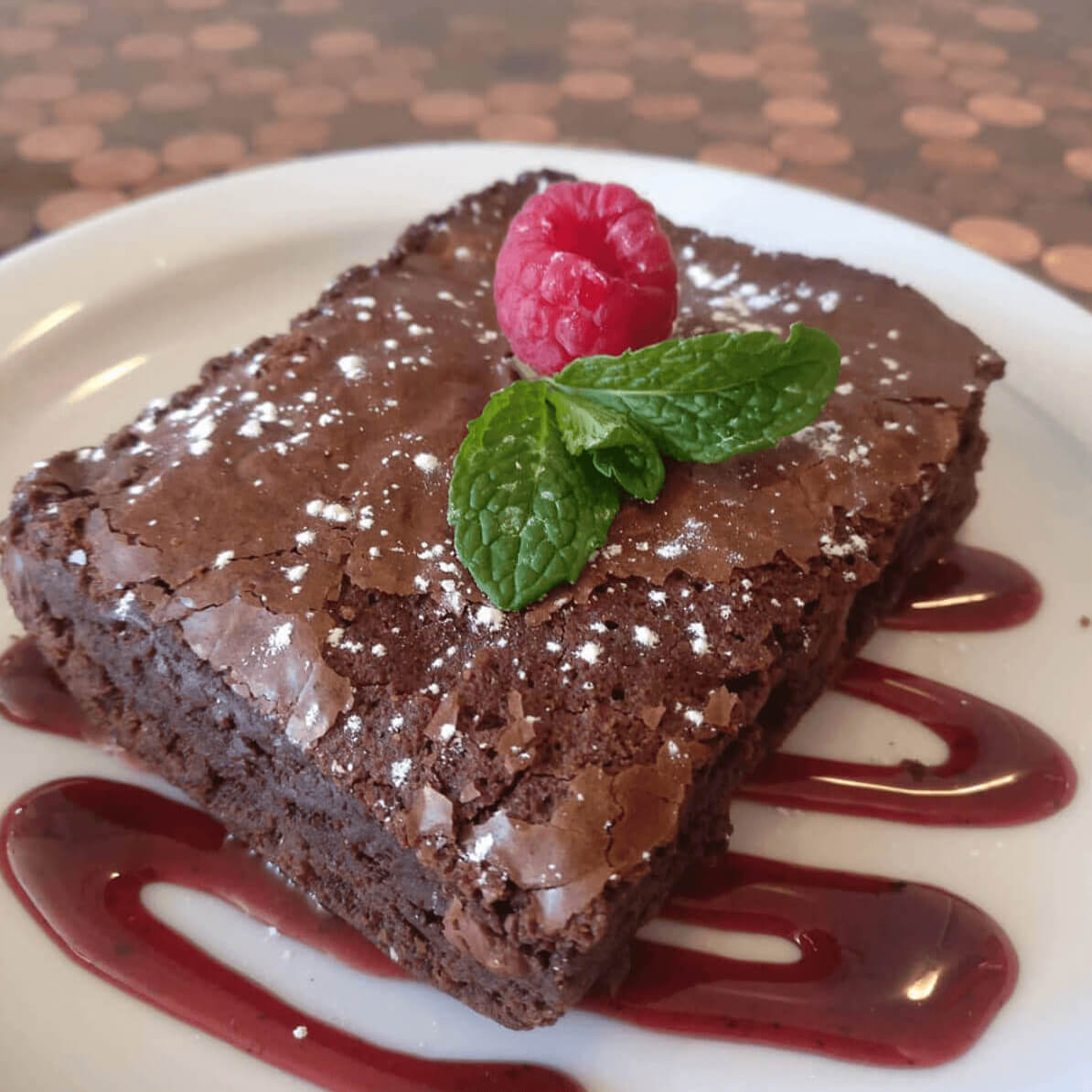 chocolate brownie with a raspberry on it